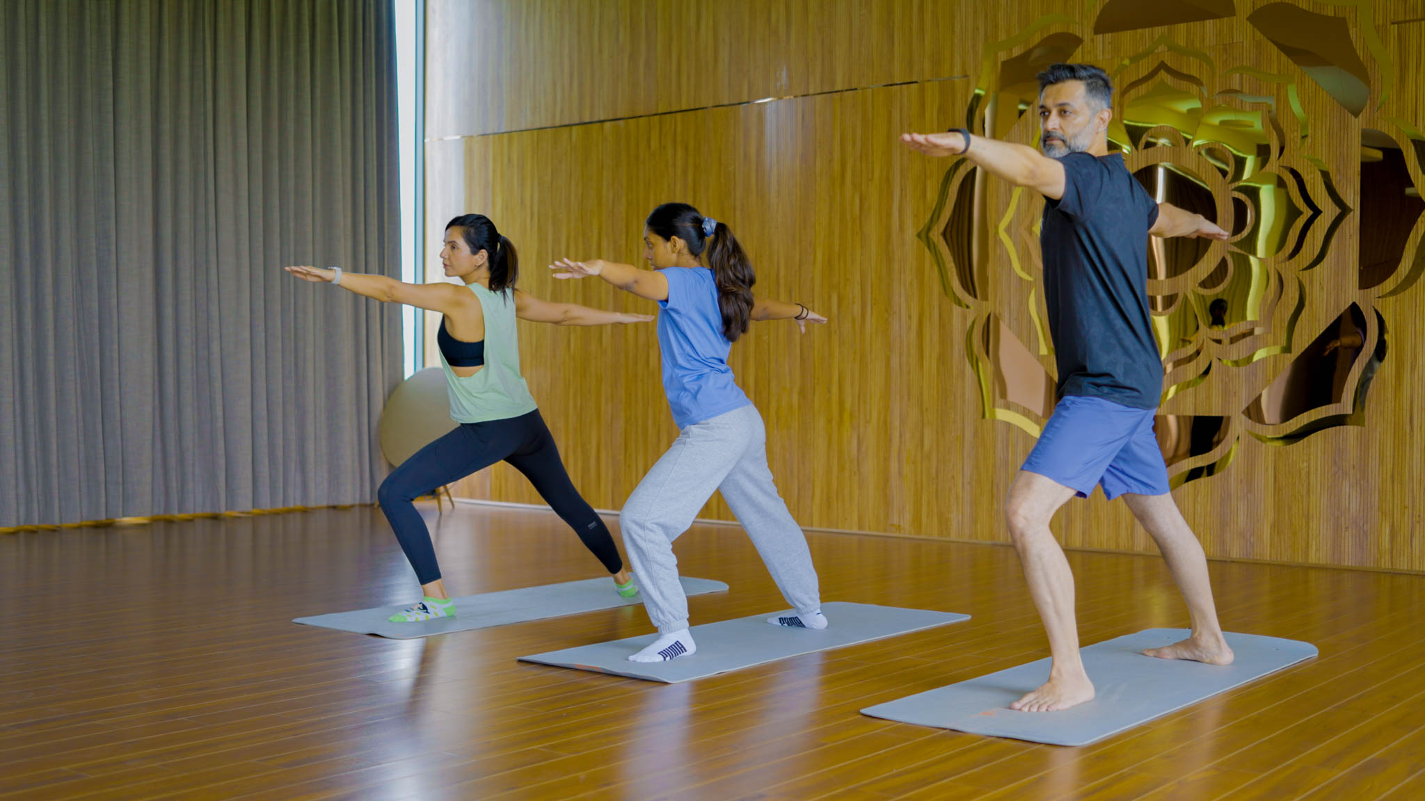 Group practicing yoga indoors together in a well-lit room during Bengaluru’s best playcation.